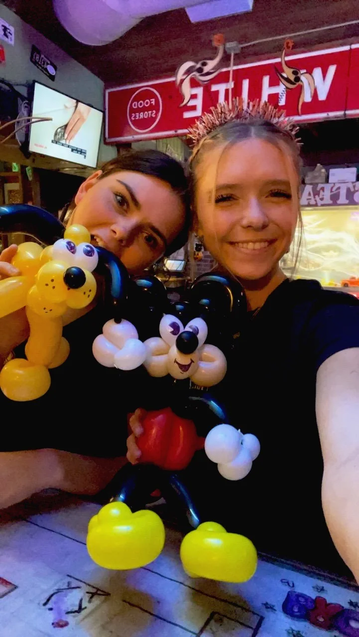 Restaurant staff smiling with detailed character balloon sculptures